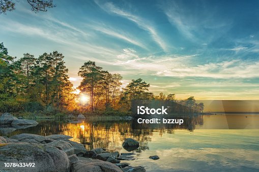 istock Autumn landscape on the lake at sunset time 1078433492