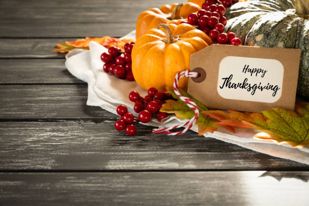 Autumn maple leaves with Pumpkin and red berries on old wooden backgound. Thanksgiving day concept. Autumn maple leaves with Pumpkin and red berries on old wooden backgound. Thanksgiving day concept. centerpiece stock pictures, royalty-free photos & images