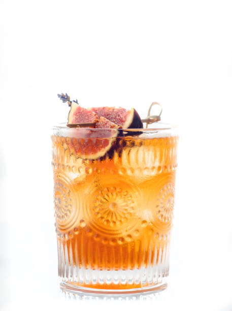 Autumn styled old fashioned cocktail with figs, honey and lavender. Selective focus. Shallow depth of field. stock photo