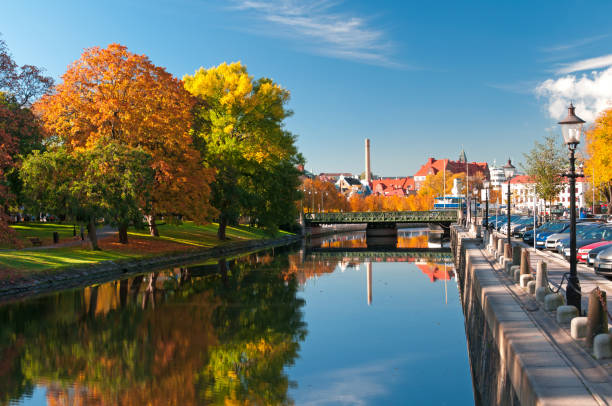autumn trees reflecting on river in rosenlundskanalen - gothenburg bildbanksfoton och bilder