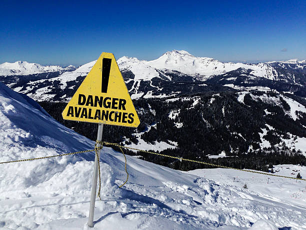 avalanche danger sign in a mountain landscape - avalanche stok fotoğraflar ve resimler