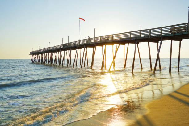 Avalon Pier and beach at the Outer Banks of North Carolina at sunrise stock photo