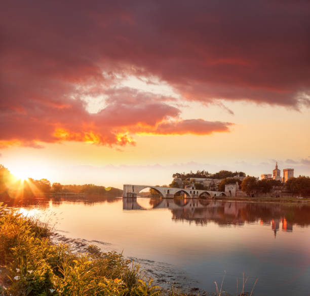 Avignon old bridge against colorful sunset in Provence, France stock photo