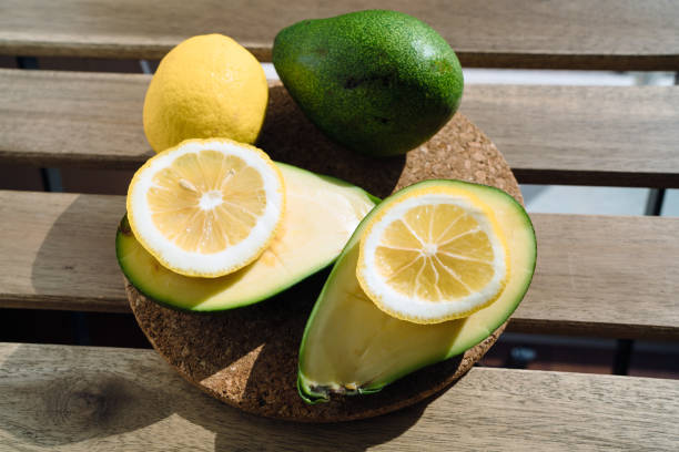 Avocado and slices of lemon stock photo