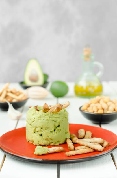 Avocado Hummus with mini grissini, rulstic still life stock photo