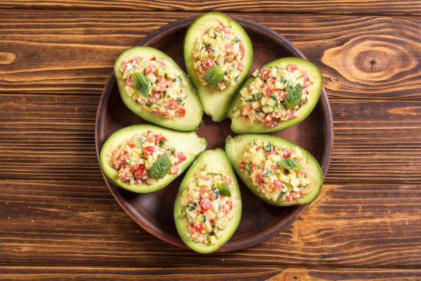Avocado stuffed with cucumber , tomatoes and eggs stock photo