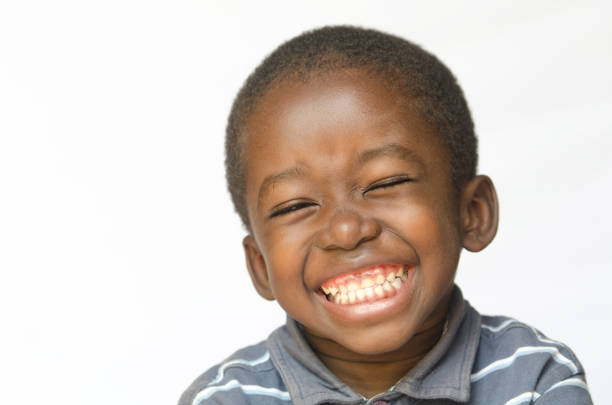 Awesome huge smile on black African ethnicity black boy child isolated on white Portrait stock photo