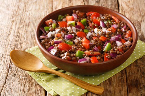 Azifa is a popular Ethiopian salad consisting of green lentils, finely chopped tomatoes, and onions close up in the plate. Horizontal stock photo