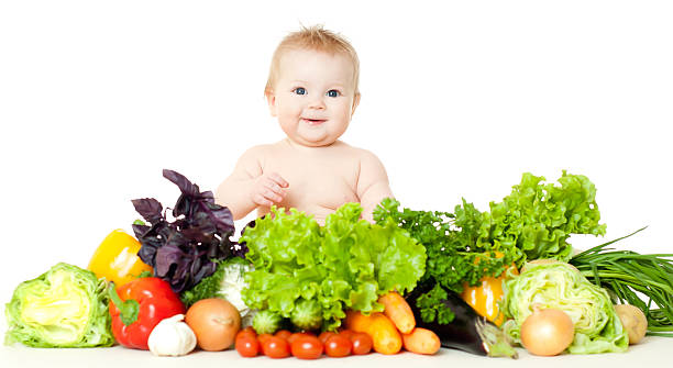 babe with vegetables stock photo