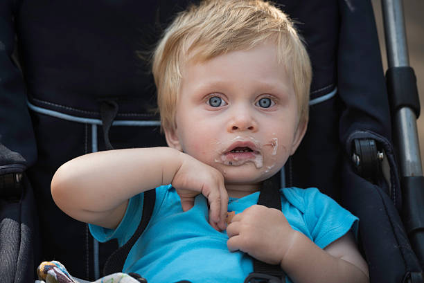 Baby after eating a dessert stock photo