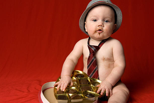 Baby and a box of chocolate stock photo