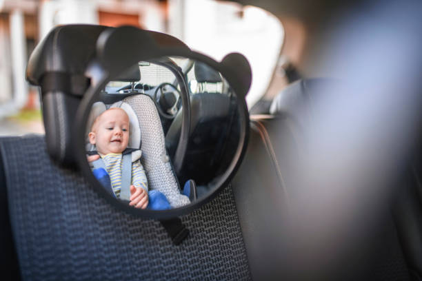 Baby boy in a car safety seat stock photo