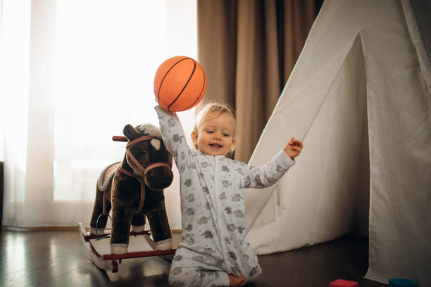 Baby Boy playing with building Blocks and an Basketball stock photo
