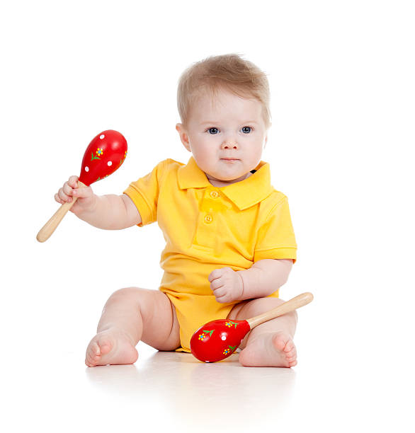 Baby  boy with musical toys on white background stock photo