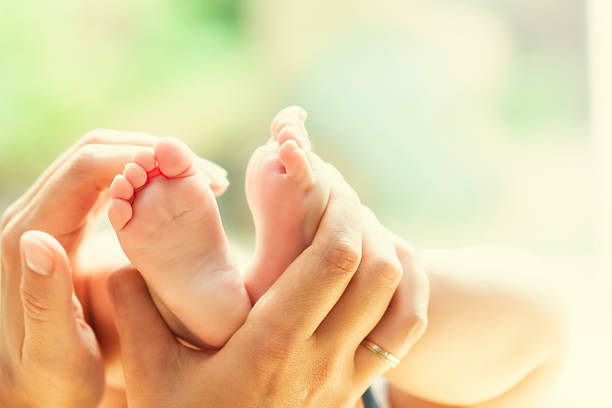 Baby feet massage stock photo