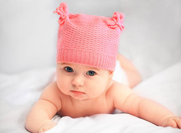 baby girl in pink hat stock photo