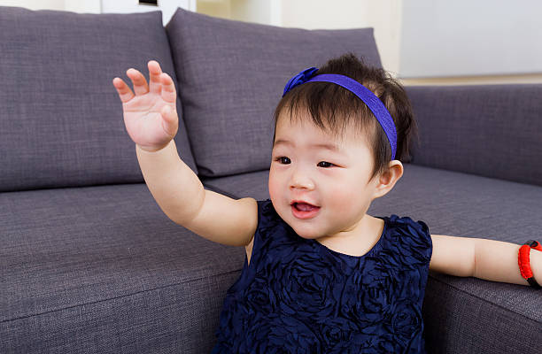 Baby girl waving hand stock photo
