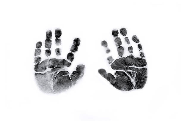 Baby Handprints in Black Ink Photograph of Newborn baby handprints in black ink on white paper. handprint stock pictures, royalty-free photos & images