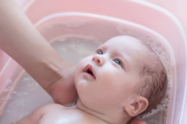 baby in the bath stock photo
