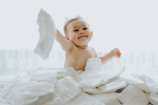 Baby is playing on diapers stock photo