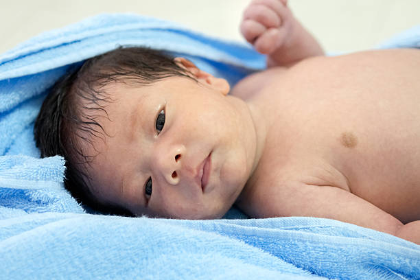 baby lie on blue towel. stock photo