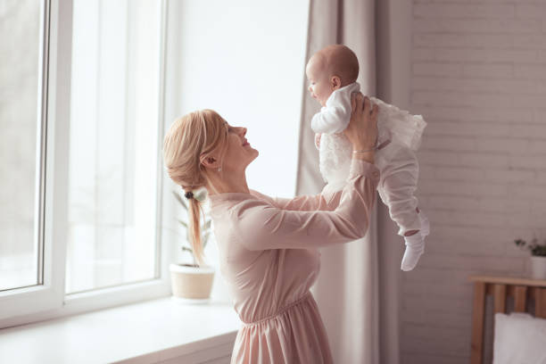 Baby on mother hands stock photo