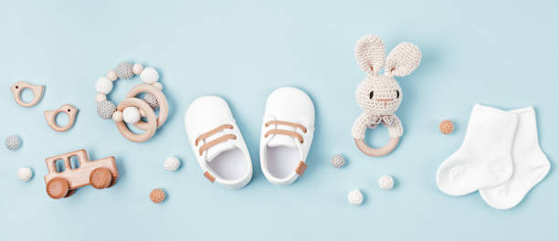 Baby shoes and teethers banner. Organic newborn accessories, branding, small business idea. stock photo