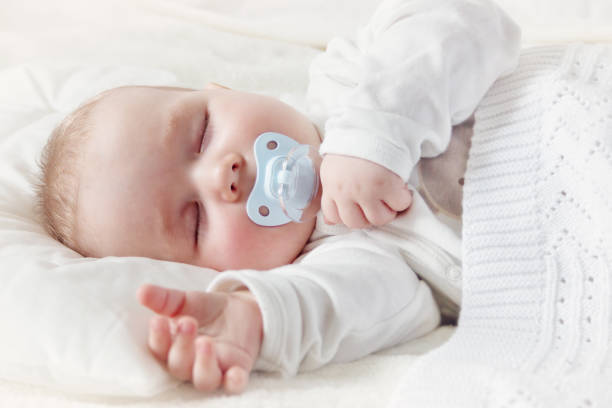 Baby sleeping covered with soft blanket stock photo