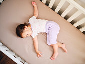 istock Baby Sleeping in a Crib 1329903707