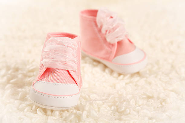baby slippers in soft plaid stock photo