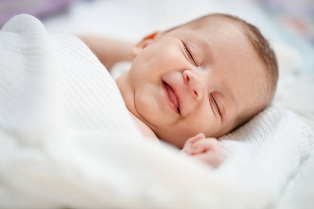 Baby smile in dreams stock photo