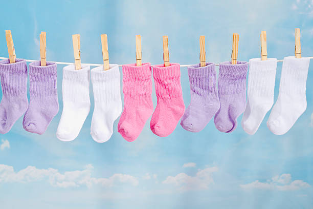 Baby Socks Hanging On A Clothesline Baby Socks Hanging On A Clothesline it's a girl stock pictures, royalty-free photos & images