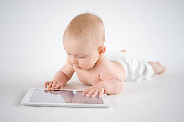 Baby using Tablet PC stock photo