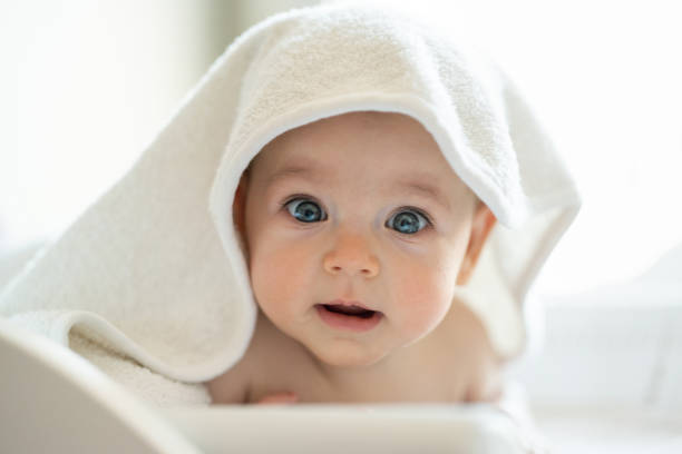 Baby wearing towel after bath stock photo