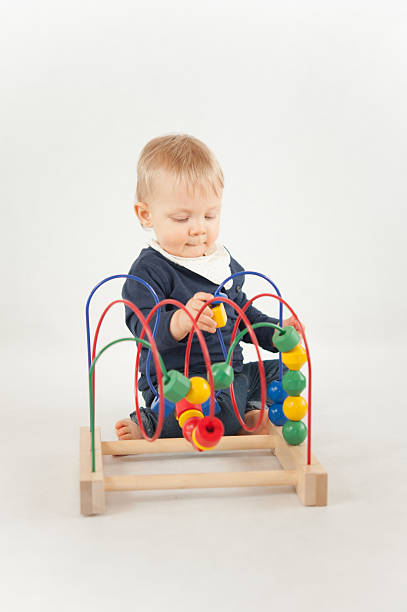 Baby With Bead Toy stock photo