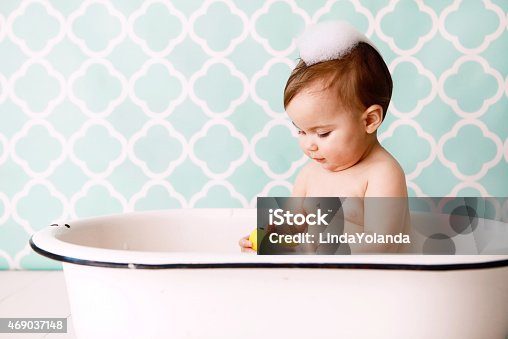 istock Baby with Rubber Ducky in Antique Bathtub 469037148