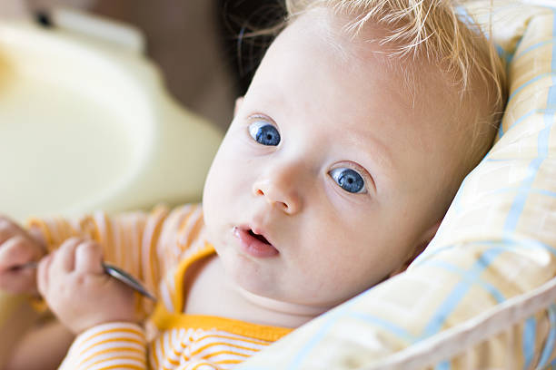Baby with spoon stock photo
