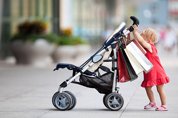 Baby-shopping Young girl with carriage carriage stock pictures, royalty-free photos & images