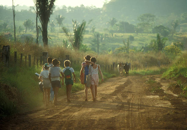 Back to school I used a 35mm slide film !Children on the way to school in the morning in a remote place of the brazilian amazon. developing countries stock pictures, royalty-free photos & images