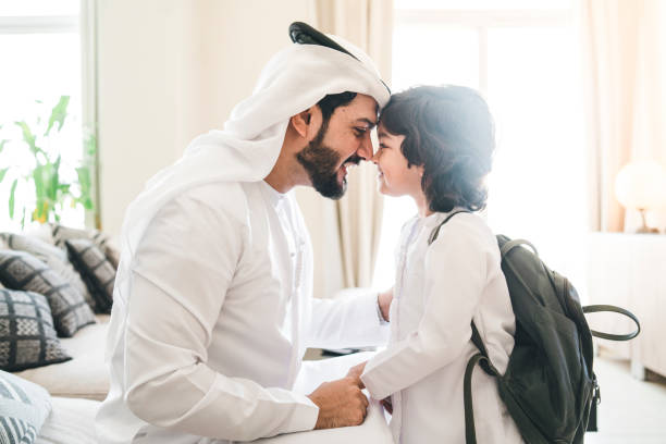 Back to school time: arab dad saying hello to his son  middle eastern culture stock pictures, royalty-free photos & images