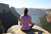 istock Back view of a yogi practicing yoga on a cliff 1346015262