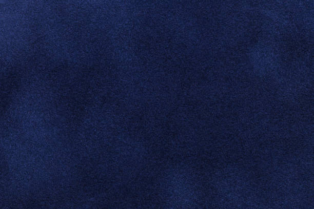 Background of dark blue suede fabric closeup. Velvet matt texture of navy blue nubuck textile Background of dark blue suede fabric closeup. Velvet matt texture of navy blue nubuck textile. velvet stock pictures, royalty-free photos & images
