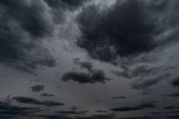 background of dark dramatic sky with stormy clouds before rain or snow, extreme weather stock photo