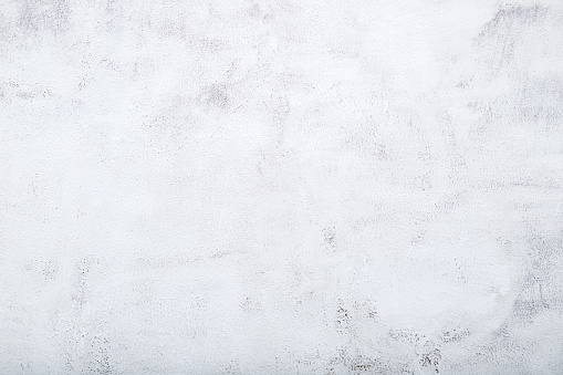 Background of old aged rough white painted concrete with stains texture .Vintage white concrete background top view.
