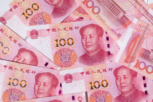 Background of scattered one hundred Chinese Reminbi yuan banknotes Background of scattered one hundred Chinese Reminbi yuan banknotes with Mao Zedong portrait. Macro top view. chinese currency stock pictures, royalty-free photos & images