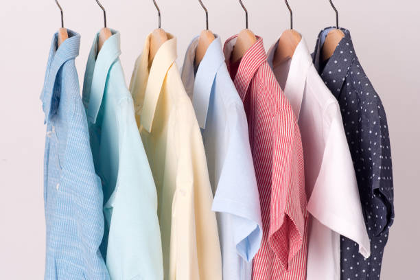 background of shirts hanging on hanger background of shirts hanging on hanger. men's fashion stock pictures, royalty-free photos & images