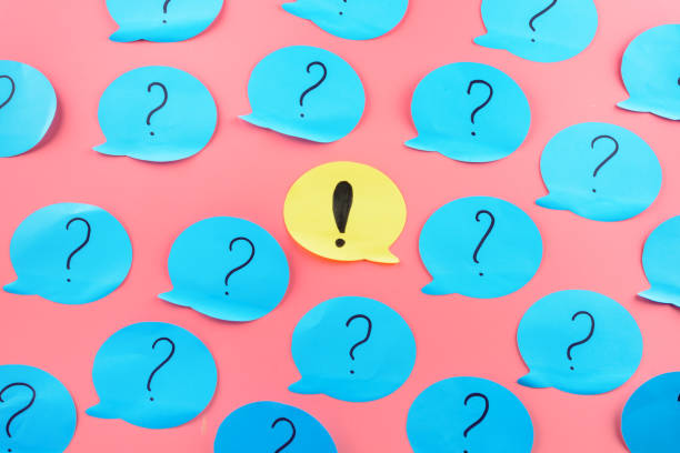 Background , stickers. Exclamation point in the center. Question marks written on blue papers. stock photo