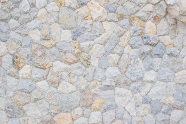 Background texture of Medieval natural stone wall textured background. Background texture of Medieval natural stone wall textured background or boundary the Rock seamless abstract and fragment of a walls from a gray chipped stones ancient. crag stock pictures, royalty-free photos & images