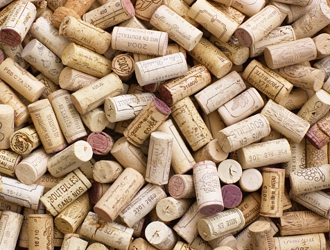 background with many French wine bottle oak corks