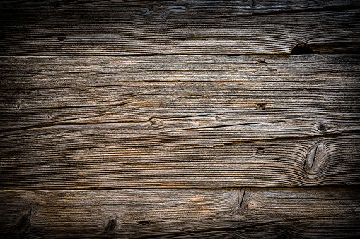 Top view of a weathered wooden plank with horizontal stripes. Predominant color is brown. XXXL 42Mp studio photo taken with SONY A7rII and Zeiss Batis 40mm F2.0 CF